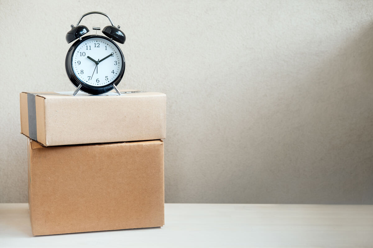 clock placed on shipping boxes